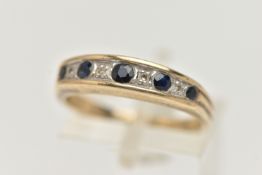 A 9CT GOLD SAPPHIRE AND DIAMOND HALF ETERNITY RING, designed with a row of five graduated circular