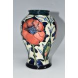 A MOORCROFT POTTERY BALUSTER VASE DECORATED WITH POPPIES ON A PALE GREEN AND DARK BLUE GROUND, circa