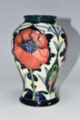 A MOORCROFT POTTERY BALUSTER VASE DECORATED WITH POPPIES ON A PALE GREEN AND DARK BLUE GROUND, circa