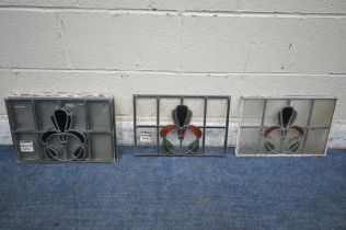 A SET OF NINE RECTANGULAR LEAD GLAZED STAINED GLASS WINDOWS, with a central floral design, 45cm x