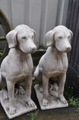 A PAIR OF COMPOSITE GARDEN SITTING DOG STATUES
