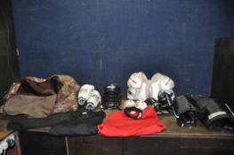 A BAG CONTAINING ICE HOCKEY CLOTHING, PADS AND HELMET by Reebok, CCM, Bauer, Sherwood etc T shirts