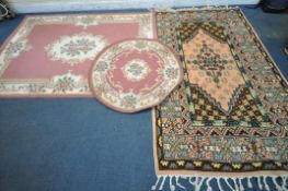 THREE VARIOUS RUGS, to include a Dunelm pink ground Chinese style rug, with central medallion and