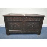 A GEORGIAN OAK COFFER, the hinged lid enclosing a candle box, repeating scrolled carving and front