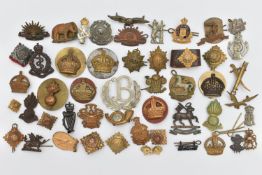 AN ASSORTMENT OF CAP BADGES, a selection of cap badges and pins from various military regiments