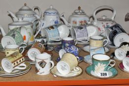 A GROUP OF WEDGWOOD AND ROYAL DOULTON COFFEE CUPS AND FIVE COMPTON AND WOODHOUSE TEAPOTS, 'The First