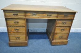A 20TH CENTURY OAK TWIN PEDESTAL DESK, fitted with nine drawers, width 122cm x depth 56cm x height