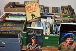 FOUR BOXES OF MILITARY THEMED BOOKS AND MAGAZINES, over one hundred titles in hardback and paperback