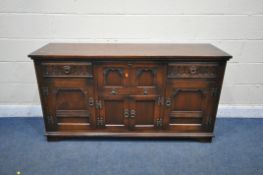 A 20TH CENTURY OAK SIDEBOARD, fitted with two drawers, four cupboard doors and a fall front door,
