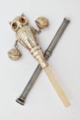 A BABY RATTLE AND A PROPELLING PENCIL, the rattle in the form of a realistically textured owl with