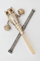 A BABY RATTLE AND A PROPELLING PENCIL, the rattle in the form of a realistically textured owl with