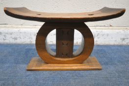A 20TH CENTURY HARDWOOD TRIBAL CARVED ASHANTI STOOL, with a bowed seat raised on circular and