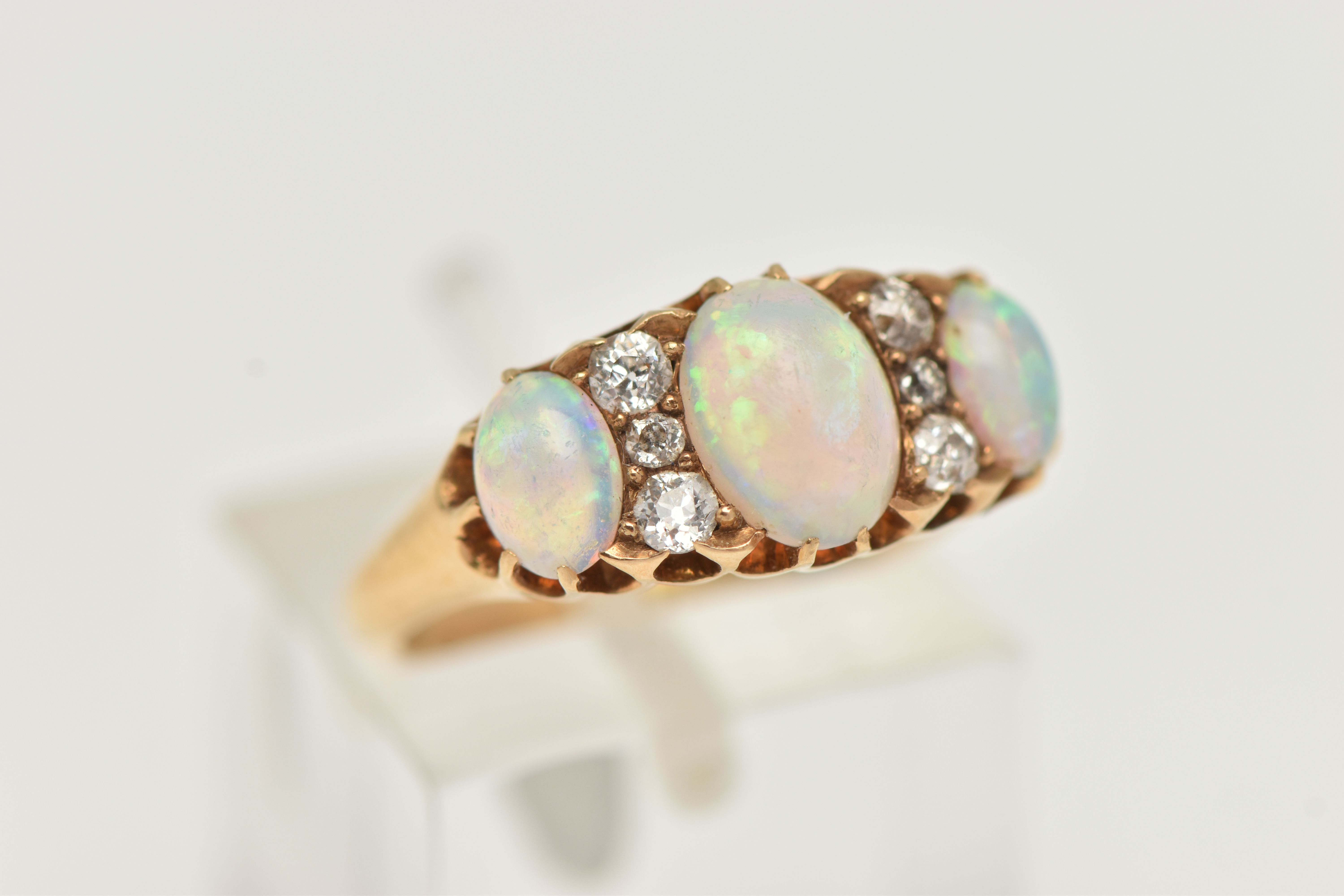 AN EARLY 20TH CENTURY OPAL AND DIAMOND RING, three oval cabochon opals prong set in yellow metal, - Image 4 of 4