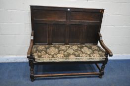 A 20TH CENTURY OAK HALL SETTLE, with a high panelled back, swept open armrests, turned and block