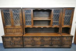 A JAYCEE OAK FOUR SECTION WALL CABINET, comprising a dresser, fitted with an arrangement of two lead