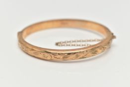 A CHILDS 9CT YELLOW GOLD HINGED BANGLE, hollow bangle with an engraved foliate pattern, push piece