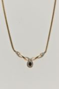 A 9CT GOLD SAPPHIRE AND DIAMOND PENDANT NECKLACE, pendant set with a pear cut deep blue sapphire,