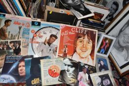 FIVE BOXES OF CLIFF RICHARD BOOKS, VIDEOS, RECORDS AND PICTURES, to include framed prints,