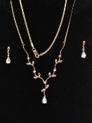 A 9CT GOLD NECKLACE AND DROP EARRINGS, the necklace designed as a V-shape foliate line set with