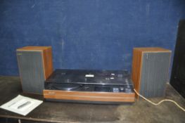 A VINTAGE SHARP SG-315E MUSIC CENTRE with matching speakers (PAT pass and working but tape player