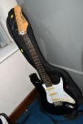 AN ENCORE COASTER STRATOCASTER STYLE ELECTRIC GUITAR, with a black finish, maple neck and tremolo,