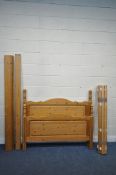 A MODERN PINE 4FT6 BEDSTEAD, with side rails, slats and central support beam (condition report: