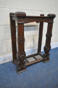 A 20TH CENTURY OAK GOTHIC STYLE STICK STAND, with three divisions, geometric and scrolled carved