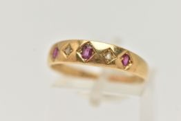 A LATE VICTORIAN YELLOW METAL, RUBY AND DIAMOND RING, designed with a row of three circular cut