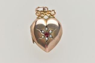 A YELLOW METAL HEART SHAPE LOCKET PENDANT, polished heart with ruby and split pearl detail,