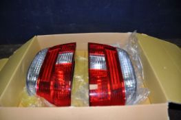 A BOXED PAIR OF AFTERMARKET TAIL LIGHTS FOR A BMW 5 SERIES E39