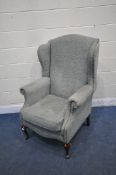 A WING BACK ARMCHAIR, with scrolled armrests, on front cabriole legs, width 82cm x depth 85cm x