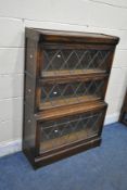 A 20TH CENTURY OAK SECTIONAL BOOKCASE, with fall front lead glazed doors, width 84cm x depth 33cm