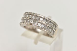 A DIAMOND DRESS RING, designed as two rows of princess cut diamonds, each row flanked by brilliant