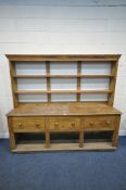 A 19TH CENTURY PINE DRESSER, with a two tier plate rack, above three drawers and an undershelf,