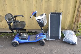 A LIBERTY MOBILITY SCOOTER with front basket, two keys and charger along with a pair of threshold