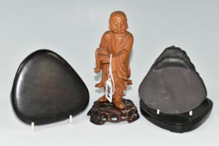 AN ORIENTAL CARVED WOOD FIGURINE, a boxwood carved figure of a smiling Chinese monk bearing a basket