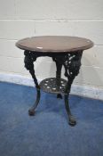 A VICTORIAN STYLE PUB TABLE, with a stained wooden top, on a black painted cast iron tripod base,