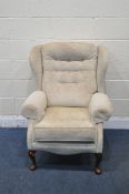A BEIGE UPHOLSTERED WING BACK ARMCHAIR, width 78cm x depth 87cm x height 102cm (condition report: