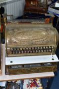 A LATE 19TH CENTURY NATIONAL CASH REGISTER BRASS TILL, serial no.298179, with till roll container,
