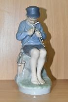 A ROYAL COPENHAGEN FIGURINE, figure of a child fisherman, number 905, marked beneath, height 20cm (