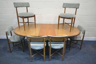 A MID CENTURY TEAK G PLAN FRESCO OVAL EXTENDING DINING TABLE, with a single fold out leaf, on