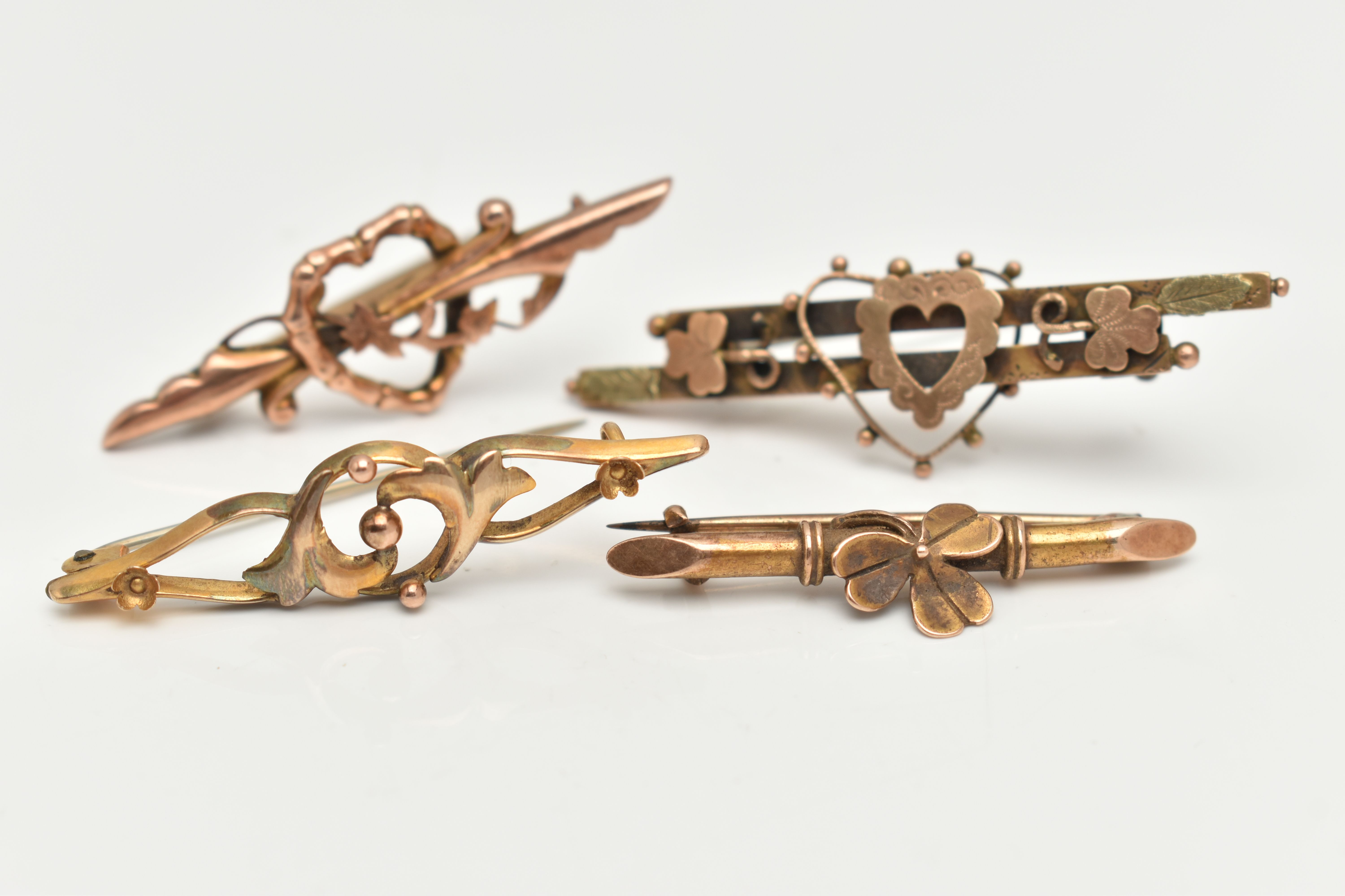 FOUR EARLY 20TH CENTURY BAR BROOCHES, the first a 9ct gold bar brooch with open heart detail,