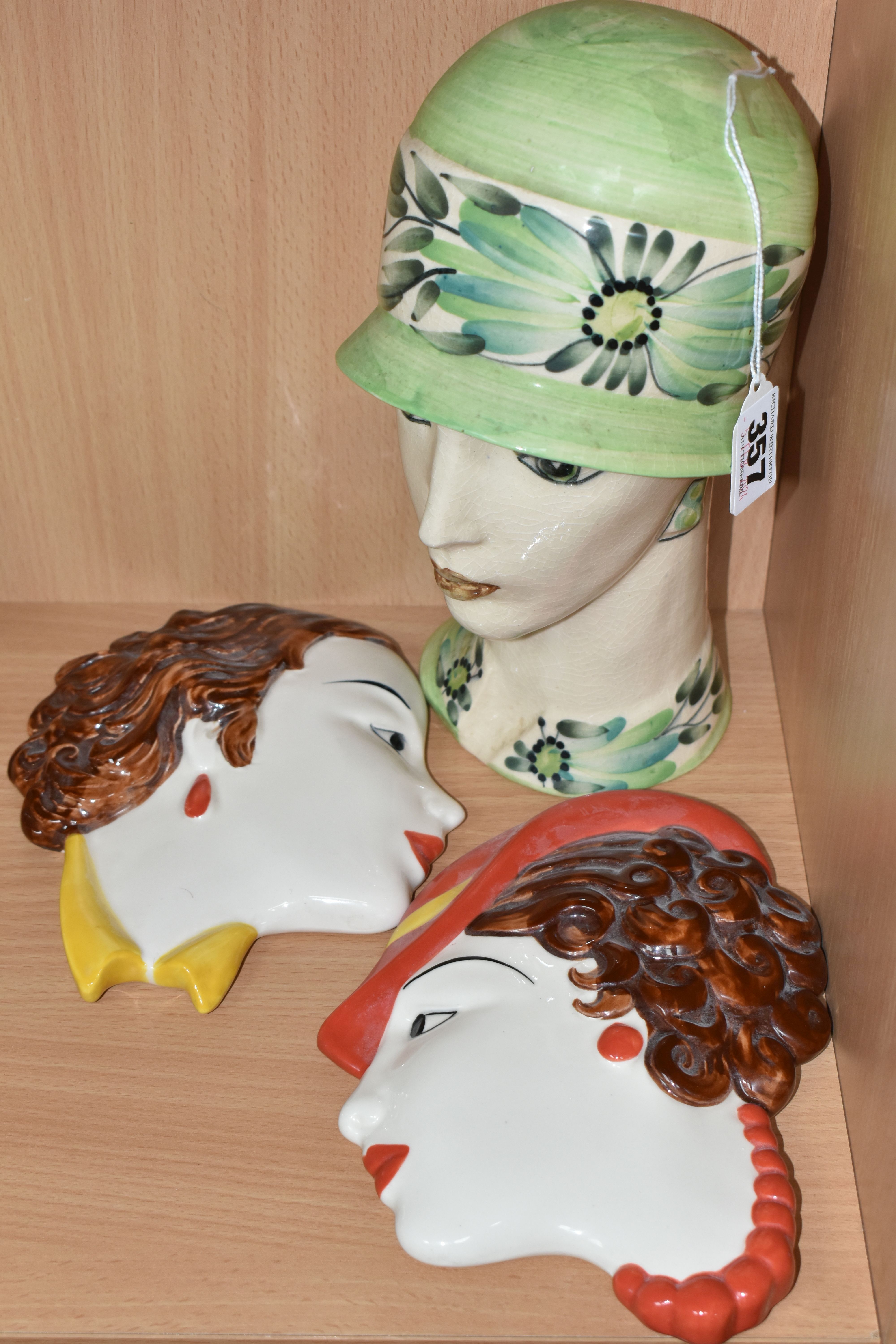 TWO MOORLAND POTTERY WALL MASKS AND A 1920'S STYLE BUST, comprising two Moorland Pottery Art Deco