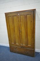 AN EARLY 20TH CENTURY PINE CABINET, with double doors above a single deep drawer, width 128cm x