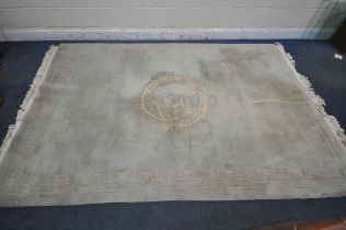 A GREEN GROUND KAYAM WOOLEN RUG, with a cental medallion depicting a Chinese dragon and a