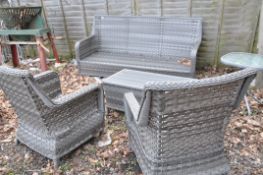 A MODERN GREY RATTAN EFFECT CONSERVATORY SUITE consisting of a three seat sofa, two chairs and a