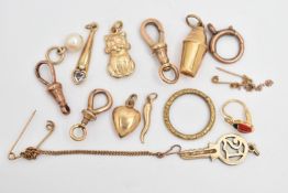 AN ASSORTMENT OF 9CT GOLD AND YELLOW METAL, to include a 21 key charm and a cocktail shaker charm,