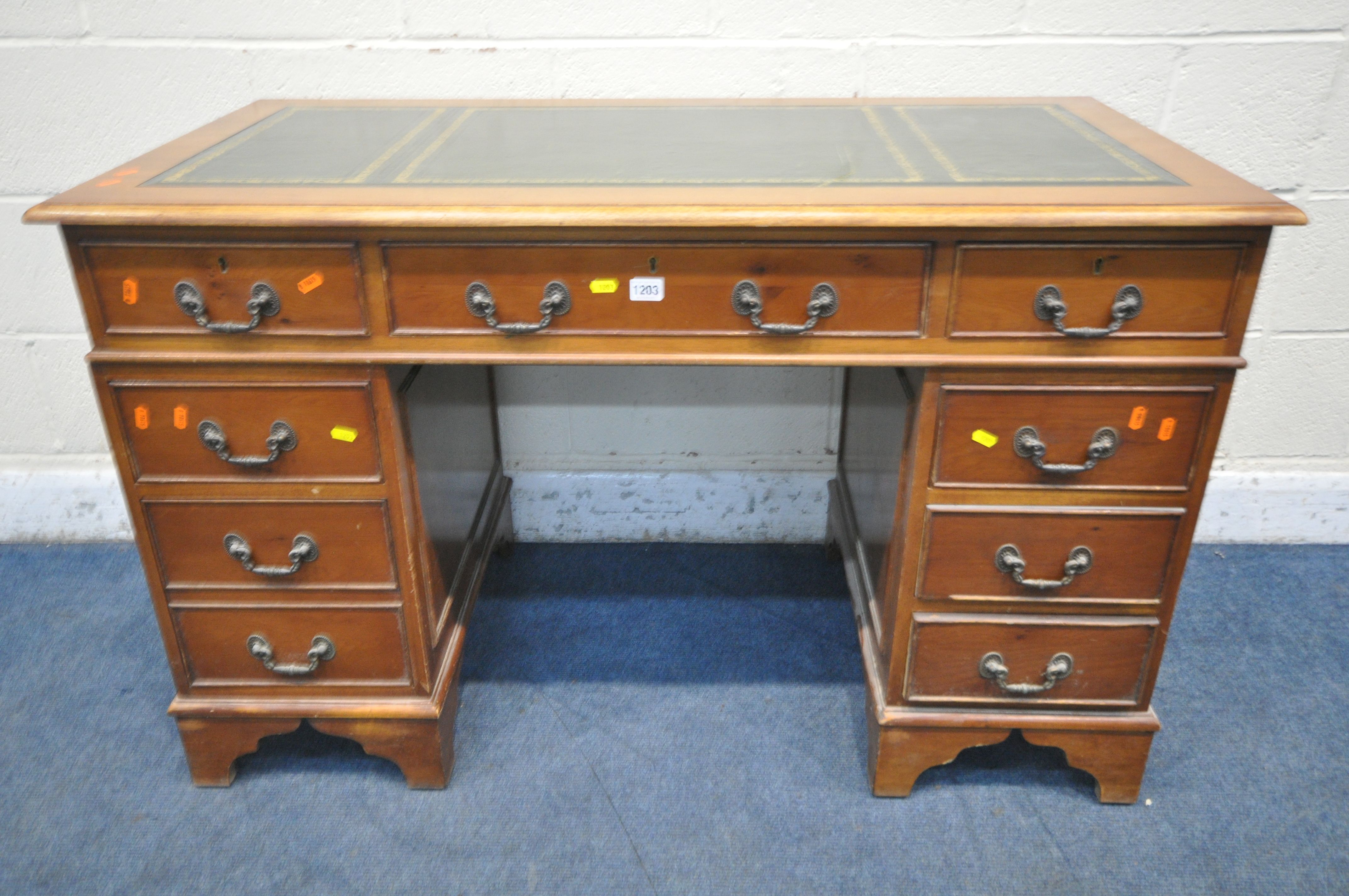 A 20TH CENTURY YEWWOOD TWIN PEDESTAL DESK, with a green tooled leather writing surface, fitted