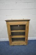 A PINE HANGING BOOKCASE, with a single glazed door, above a single drawer, width 89cm x depth 36cm x
