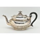 AN EDWARDIAN SILVER TEAPOT, oval form with a polished and stop reeded pattern, engraved crest